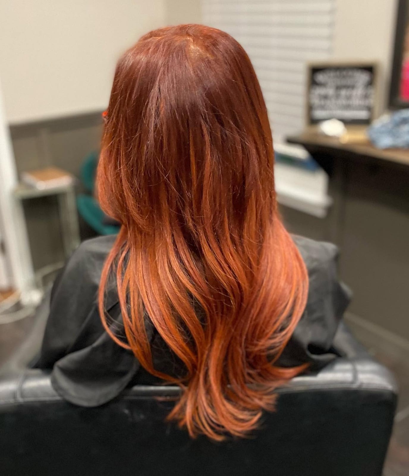 Kelanie applying a rich red hair color for a client
