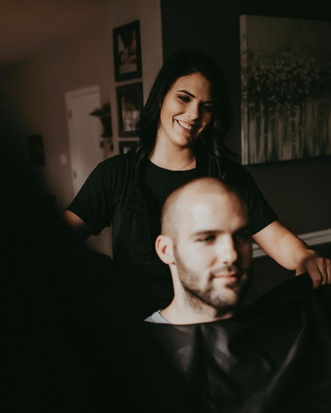 Kelanie giving a men's haircut and beard trim